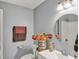 Bright bathroom featuring updated vanity, lighting, and a decorative floral display at 1784 Virginia Grove Ln, Lawrenceville, GA 30045