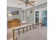 Bedroom showcasing stylish gray walls, a ceiling fan, and glass paneled doors at 1784 Virginia Grove Ln, Lawrenceville, GA 30045