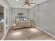 Spacious bedroom featuring stylish gray walls, a ceiling fan, and french doors at 1784 Virginia Grove Ln, Lawrenceville, GA 30045