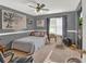 Bedroom featuring neutral tones, art pieces and a window with sunlight shining through at 1784 Virginia Grove Ln, Lawrenceville, GA 30045