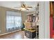Cozy bedroom featuring a ceiling fan, natural light from the window, and an organized closet space at 1784 Virginia Grove Ln, Lawrenceville, GA 30045
