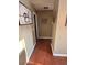 Hallway with hardwood floors, beige walls, decorative wall art, and a well-lit ambiance at 1784 Virginia Grove Ln, Lawrenceville, GA 30045