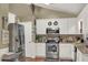 Well-equipped kitchen with stainless steel appliances, granite countertops, and white cabinetry at 1784 Virginia Grove Ln, Lawrenceville, GA 30045