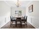 Elegant dining room featuring a modern chandelier, stylish chairs, and neutral wall décor at 1786 Jameson Cir, Lawrenceville, GA 30043