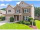 Beautiful two-story home with lush green lawn, mature landscaping, and a two-car garage on a sunny day at 1786 Jameson Cir, Lawrenceville, GA 30043