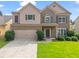 Charming two-story home featuring a well-manicured lawn, a two-car garage, and a welcoming front porch at 1786 Jameson Cir, Lawrenceville, GA 30043