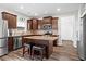 A kitchen with granite countertops, stainless appliances, dark wood cabinets and a central island at 1786 Jameson Cir, Lawrenceville, GA 30043
