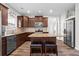 A kitchen with granite countertops, stainless appliances, dark wood cabinets and a central island at 1786 Jameson Cir, Lawrenceville, GA 30043