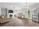 Spacious living room with hardwood floors, a cozy fireplace, and modern furniture at 1786 Jameson Cir, Lawrenceville, GA 30043