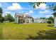 Expansive backyard featuring a two-level deck, outdoor dining area, and well-maintained lawn at 185 Fox Run, Loganville, GA 30052