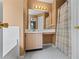 Well-lit bathroom with vanity and tub/shower combo at 185 Fox Run, Loganville, GA 30052