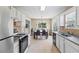 Bright kitchen with white cabinets and a view of the dining area at 185 Fox Run, Loganville, GA 30052