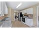 Functional kitchen with white cabinets and modern appliances at 185 Fox Run, Loganville, GA 30052