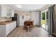 Bright kitchen with white cabinets, stainless steel appliances, and wood floors at 185 Fox Run, Loganville, GA 30052