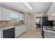 Well-lit kitchen with a view into the dining area, featuring a clean design at 185 Fox Run, Loganville, GA 30052