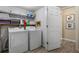 Laundry room featuring a washer, dryer, shelves, and door at 185 Fox Run, Loganville, GA 30052