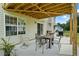 Covered patio with table, chairs, barbecue grill and nice backyard view at 185 Fox Run, Loganville, GA 30052