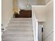 Carpeted staircase leading to the upper level, illuminated by a ceiling fan at 185 Fox Run, Loganville, GA 30052