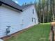 Exterior shot showcasing the side yard of the house with lush greenery at 301 Brooke View Trail, Canton, GA 30115