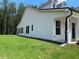 Exterior view of a white home with a covered patio and a well-maintained backyard at 301 Brooke View Trail, Canton, GA 30115