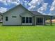 Exterior view showing an outdoor covered patio and backyard with vibrant green grass at 301 Brooke View Trail, Canton, GA 30115