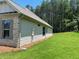 Side exterior of home with green lawn and lush forest background at 354 Brooke View Trail, Canton, GA 30115