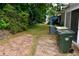 View of home's backyard featuring a patio, green grass, mature trees and AC unit at 1106 Shiloh Nw Ln, Kennesaw, GA 30144