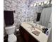 Charming bathroom with floral wallpaper, a large mirror, and a clean white toilet at 1106 Shiloh Nw Ln, Kennesaw, GA 30144