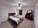 Serene bedroom with a ceiling fan, neutral walls, carpet flooring, and ample closet space for storage at 1106 Shiloh Nw Ln, Kennesaw, GA 30144