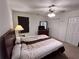 Cozy bedroom featuring a ceiling fan, closet, and a window for natural light at 1106 Shiloh Nw Ln, Kennesaw, GA 30144