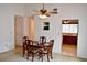 Cozy dining room with a wood table and chairs, complemented by carpet flooring and a view into the kitchen at 1106 Shiloh Nw Ln, Kennesaw, GA 30144