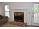 Brick fireplace with white mantle, complemented by natural light from nearby windows and a cozy seating area at 1106 Shiloh Nw Ln, Kennesaw, GA 30144
