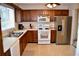 Functional kitchen with light countertops, appliances, wood cabinets, and bright natural light at 1106 Shiloh Nw Ln, Kennesaw, GA 30144