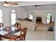 Spacious living room featuring a fireplace, with an adjacent dining area, all illuminated by natural light at 1106 Shiloh Nw Ln, Kennesaw, GA 30144