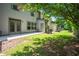 Lush backyard with grassy lawn, mature trees, and a concrete patio area at 122 Creighton Ln, Marietta, GA 30008