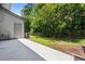 A backyard featuring a concrete patio, green lawn, fence, and a variety of trees at 122 Creighton Ln, Marietta, GA 30008