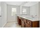 Bright bathroom with a long vanity, drawers, a white countertop and a large mirror, and a tiled floor at 122 Creighton Ln, Marietta, GA 30008