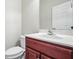 Modern bathroom featuring a vanity with a red-brown wood finish and a white countertop and sink at 122 Creighton Ln, Marietta, GA 30008