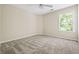 Bedroom featuring neutral walls, neutral carpet, a ceiling fan and a bright window at 122 Creighton Ln, Marietta, GA 30008