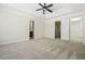 Large bedroom with neutral walls, carpet, ceiling fan, and doors to closet and bathroom at 122 Creighton Ln, Marietta, GA 30008