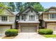 Charming townhouse with a brick facade, two-car garage and a well-maintained lawn at 122 Creighton Ln, Marietta, GA 30008