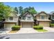 Inviting townhome exterior with neutral siding, brick accents, and lush green landscaping at 122 Creighton Ln, Marietta, GA 30008