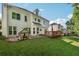 A spacious backyard with a patio, lawn, and a charming playhouse at 3272 Monarch Pine Dr, Peachtree Corners, GA 30071
