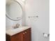 Bathroom features vanity with granite countertop, round mirror, and tile floors at 3272 Monarch Pine Dr, Peachtree Corners, GA 30071