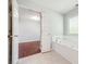 Bright bathroom featuring a large tub with tile surround and a view to the bedroom at 3272 Monarch Pine Dr, Peachtree Corners, GA 30071