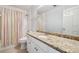 Bathroom featuring granite countertops, a shower with colorful curtains, and a large mirror at 3272 Monarch Pine Dr, Peachtree Corners, GA 30071