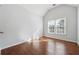 Sun-filled bedroom with hardwood floors and a large window allowing ample natural light at 3272 Monarch Pine Dr, Peachtree Corners, GA 30071