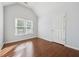 Bedroom with hardwood floors, large window, and a white door at 3272 Monarch Pine Dr, Peachtree Corners, GA 30071