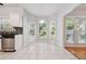 Bright breakfast nook featuring white tiled floor, view windows, and access to deck at 3272 Monarch Pine Dr, Peachtree Corners, GA 30071
