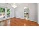Cozy dining area with hardwood floors, chandelier, and natural light filtering through the windows at 3272 Monarch Pine Dr, Peachtree Corners, GA 30071